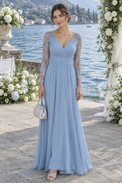 A woman wears a floor-length dusty blue gown with a V-neck, sheer lace sleeves, and a silver clutch.