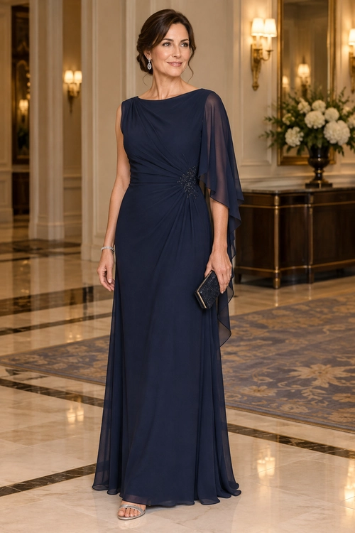 Navy Draped Evening Gown A floor-length navy gown with a sheer draped sleeve, jeweled waist detail, and a matching dark clutch.