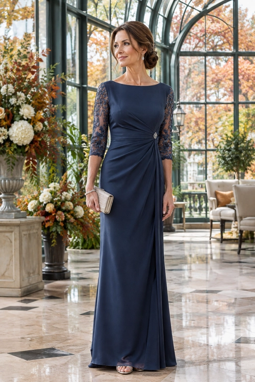 Navy Lace-Sleeve Evening Gown A floor-length navy gown with lace three-quarter sleeves and a gathered waist, styled with a light-colored clutch and open-toe sandals.
